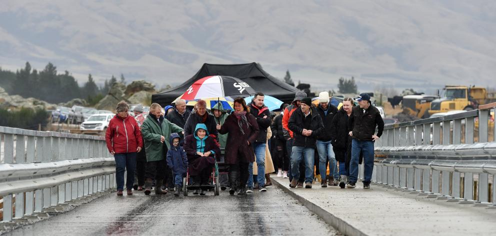 Middlemarch locals take their first steps across the new road bridge near Sutton after it was...
