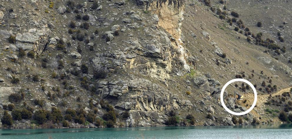 A digger (circled) works through rocky terrain in the Cromwell Gorge to build the Lake Dunstan Cycle Trail, which will eventually continue along the lake’s edge. Photos: Stephen Jaquiery