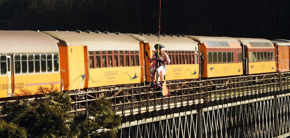 Broomstick champion Aurora Peasegood (aka Lydia Kinsman) flies past the ODT Enchanted Express as it crosses the Wingatui Viaduct. Photos: Peter McIntosh