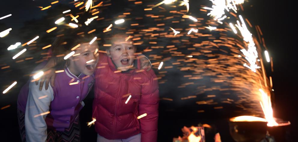 Stella Hansen (12, left) and Mikayla Wood (11), both of Mosgiel, enjoy fireworks at Unity Park,...
