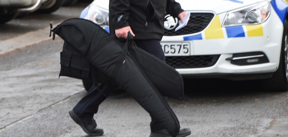 Members of the public hand in now illegal firearms at a buy back event at the Taieri Rugby Football Club, Mosgiel today. Photo: Gregor Richardson
