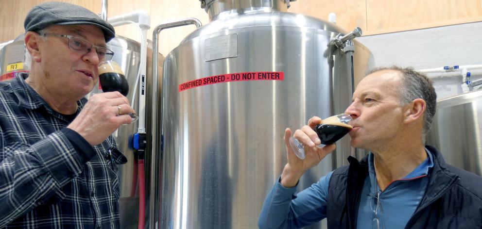 Otago Polytechnic's Central Campus brewery operations manager Ben Middlemiss (left) and lecturer Geoff Collie try the latest batch of porter at the school. Photo: Simon Henderson