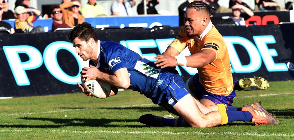 Otago halfback Rowan Gouws scores despite the efforts of North Otago replacement Toni Taufa...
