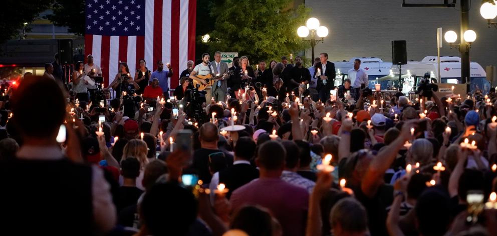 Local and state politicians and business leaders join community members for a vigil at the scene of a mass shooting in Dayton. Photo: Reuters