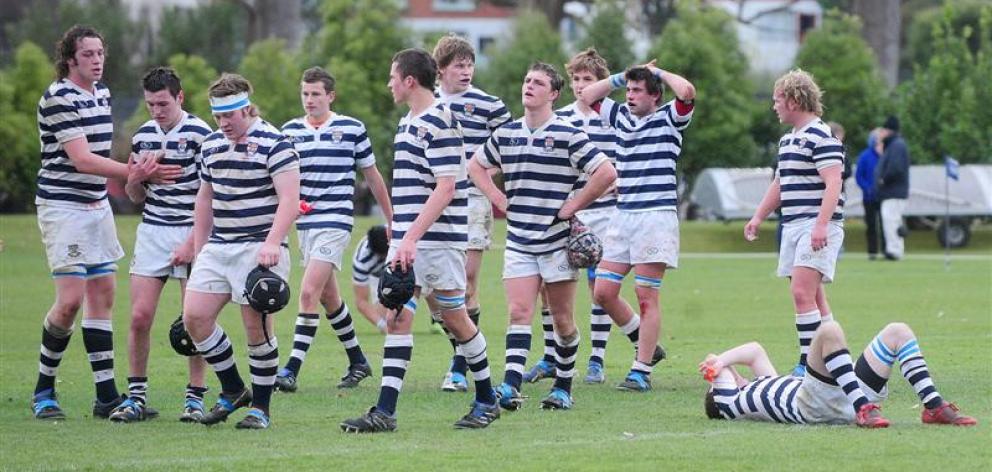 Dejected Otago Boys High School players leave the field at the University Oval on Saturday after...