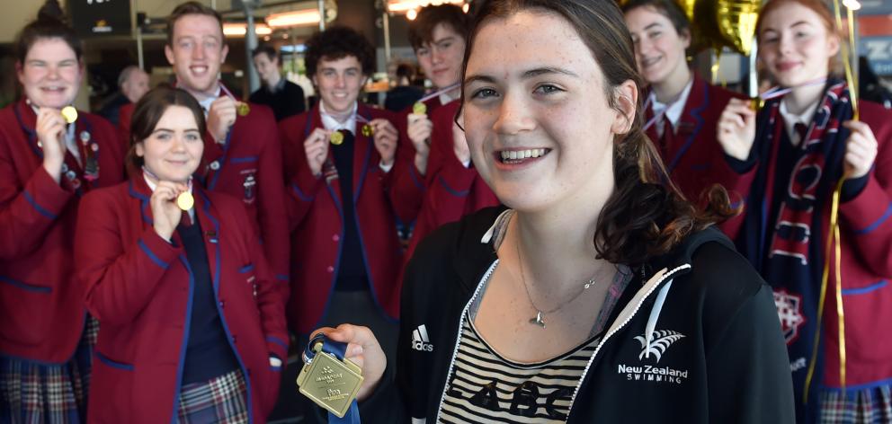 World junior swimming champion Erika Fairweather is greeted by her Kavanagh College classmates at Dunedin Airport yesterday. Photo: Peter McIntosh