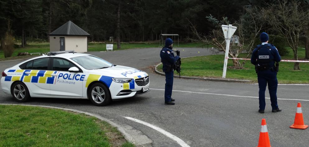 Armed police near the cordon at the Glenavy rest area. Photo: Daniel Birchfield