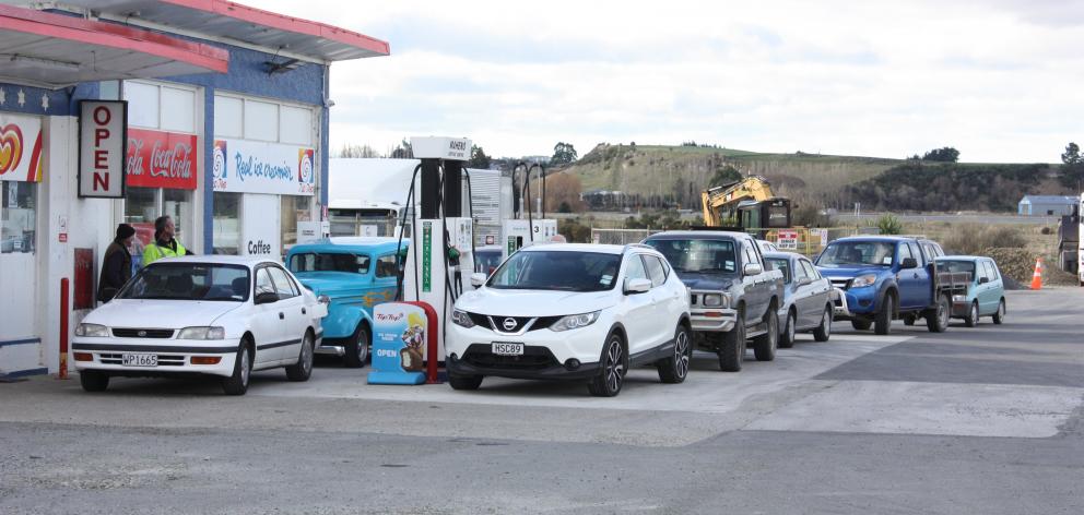 Vehicles line up at the Maheno service station to take advantage of cheap fuel yesterday. Photo: Gus Patterson