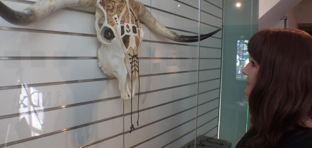 Otago Museum's Rachel Cooper admires artwork in year's iNDx exhibition. Photo: ODT