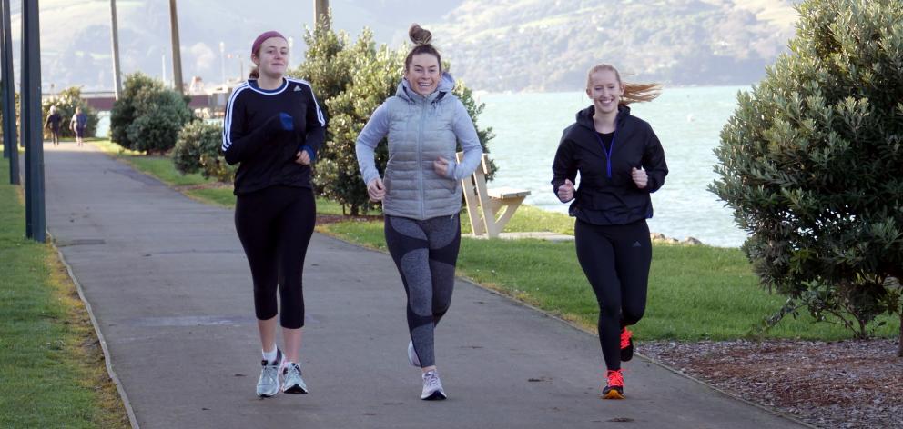 Friends (from left) Briar Waugh, Georgia Pringle and Ruby Pringle run along the cycleway-walkway in Ravensbourne in preparation for the Dunedin Marathon. Photo: Jessica Wilson