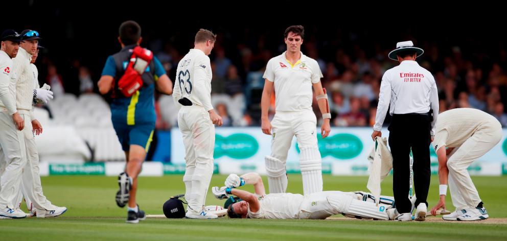 ustralia's Steve Smith lays on the floor after being hit by a ball from England's Jofra Archer as England's Jos Buttler and Australia's Pat Cummins look on. Photo: Action Images via Reuters