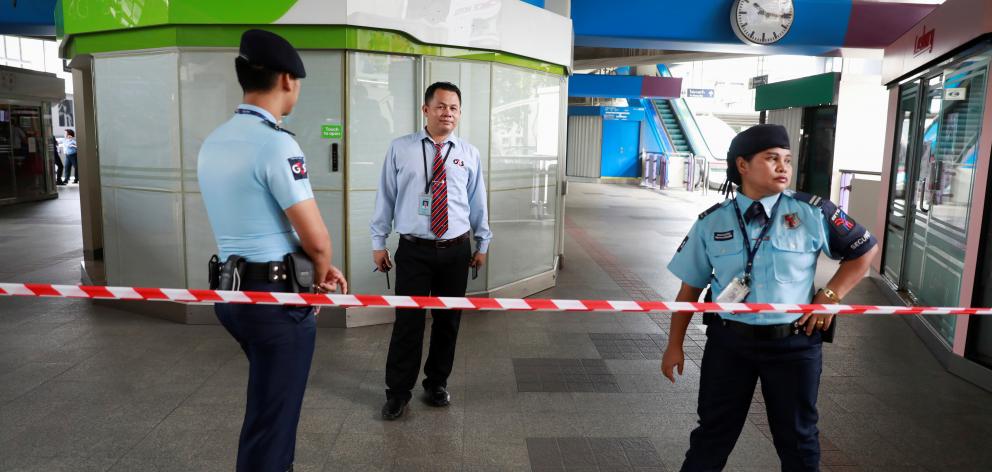 Security officers stand at the site of a small explosion at a BTS train station in Bangkok, Thailand. Photo: Reuters