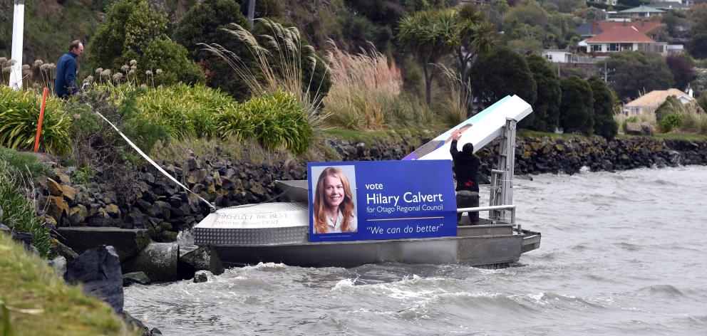 A boat covered in election signs for Cr Lee Vandervis, Russell Lund and Hilary Calvert is secured...