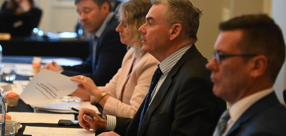 (from left) Mark Patterson (furthest), Dr Liz Craig, Scott Simpson and Michael Woodhouse listen....