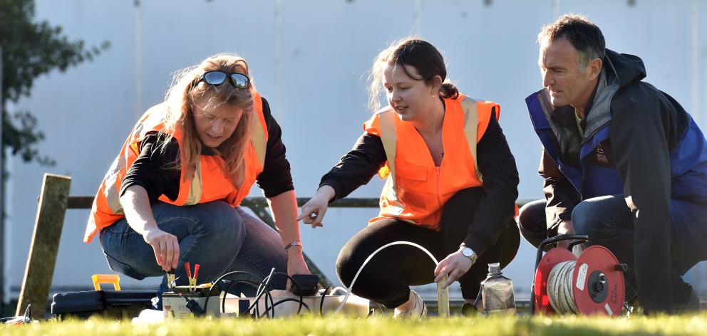 University of Otago lecturer Sarah Mager (left), masters student Sarah Yeo and GNS Science structural geologist Simon Cox test the water beneath South Dunedin. Photo: Peter McIntosh