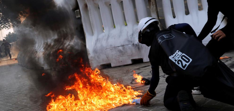 An anti-government protester prepares to throw a Molotov cocktail during a demonstration near...