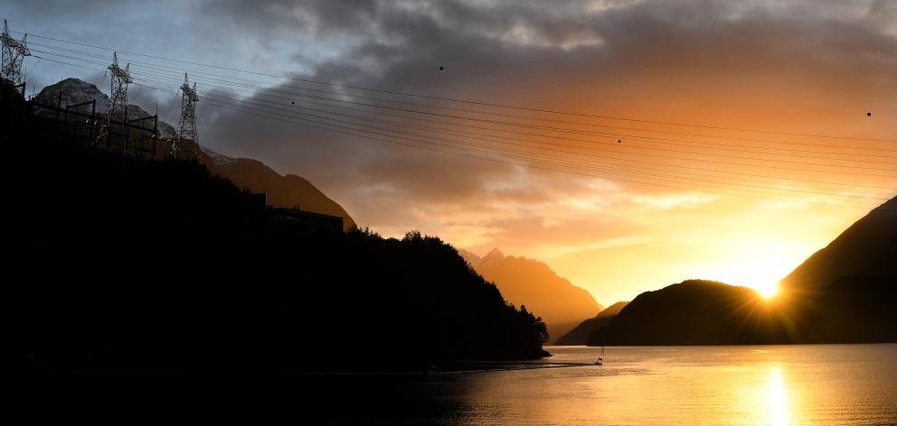 Transmission lines span West Arm at sunrise. PHOTOS: STEPHEN JAQUIERY