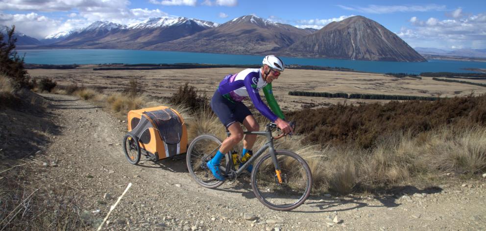 Dunedin cyclist Johnny Van Leeuwen, with dog Hugo in tow, reach the high point of the Alps 2...