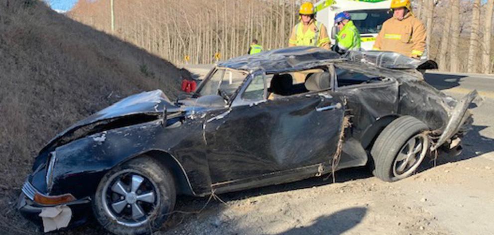 Emergency personnel attend the scene of a crash Porsche near Arrowtown. Photo: NZ Police