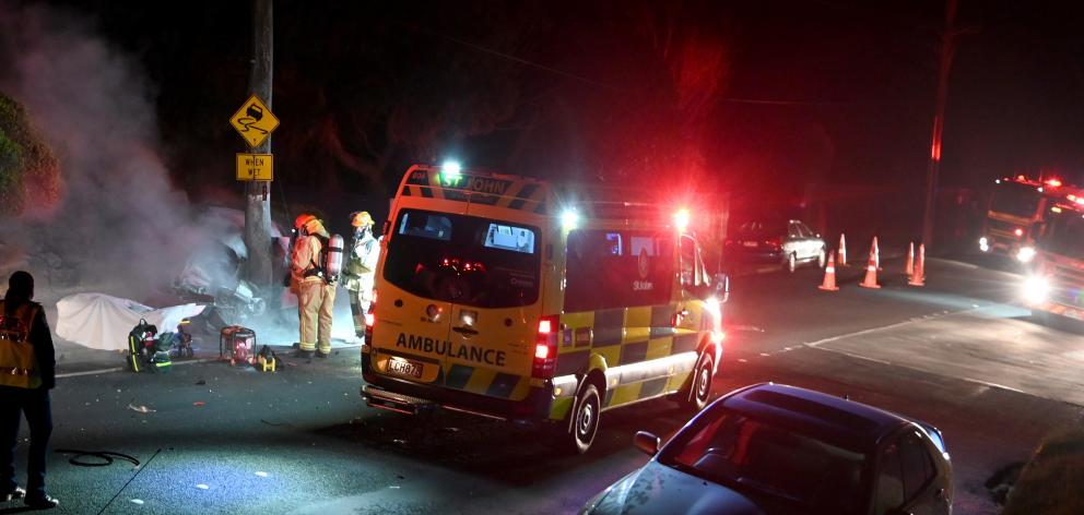 Fire and Emergency workers attend a crash scene in Corstorphine Rd last night. PHOTO: CRAIG BAXTER
