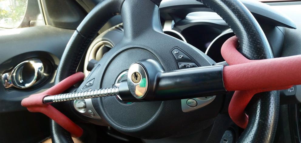 Anti-Theft Car Steering Wheel Lock. Black & red colors. Photo: Getty Images