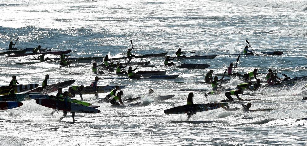 Competitors head away to White Island in the annual race at St Clair Beach on Saturday. PHOTOS:...