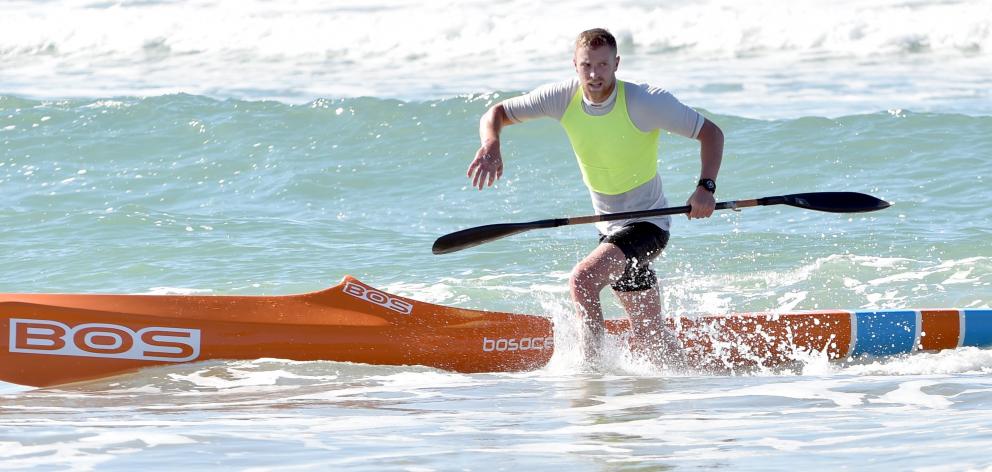 Zac Quickenden, of Christchurch, jumps off his surf ski on the way to winning the White Island...