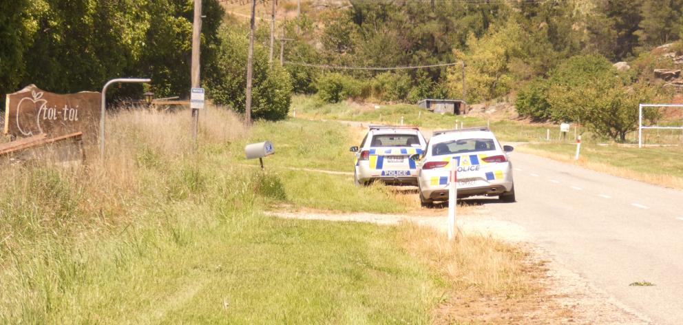 Two police cars parked up outside Toi Toi Orchards, near Alexandra, yesterday. PHOTO: ADAM BURNS