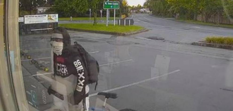 The 28-year-old man was seen approaching the store wearing a hoodie and a face mask. Photo: CCTV