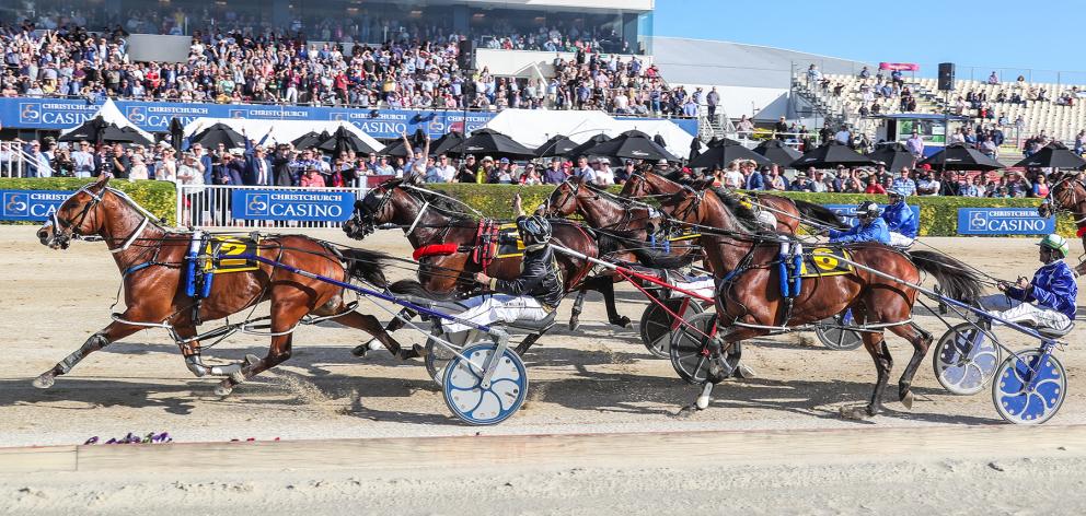 Driver Tim Williams salutes the Addington crowd as Chase Auckland wins the New Zealand Free-For...