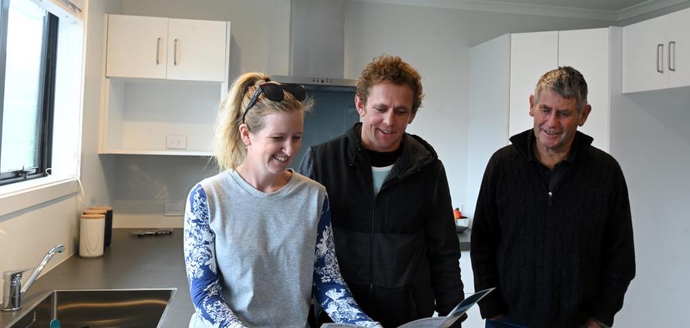 Rosie and Cody (centre) Cowley and Alan Scurr admire the kitchen of their newly-purchased charity house. PHOTOS: LINDA ROBERTSON Rosie and Cody (centre) Cowley and Alan Scurr admire the kitchen of their newly-purchased charity house. PHOTOS: LINDA ROBERTSON