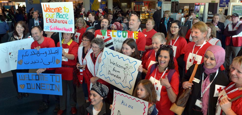Red Cross volunteers welcome the first group of Syrian refugees at Dunedin Airport in 2016. Photo...