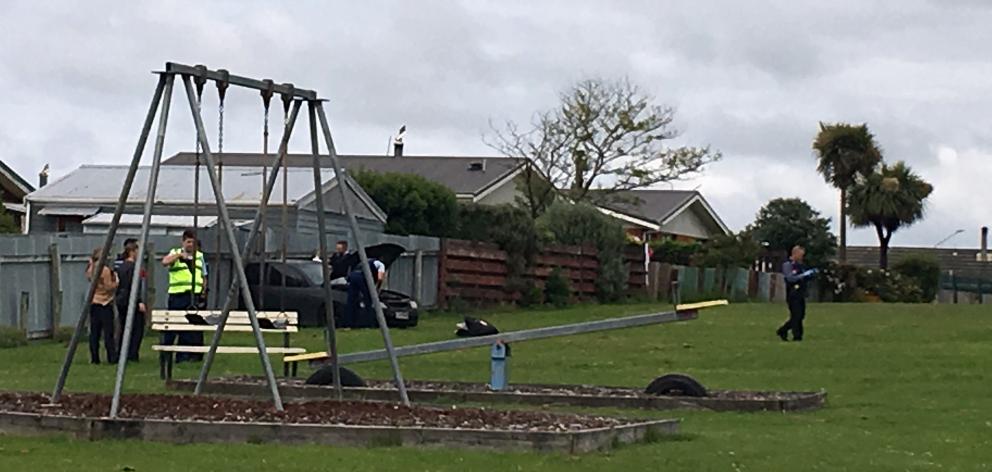 Police swarmed an Invercargill park yesterday after a driver crashed through a fence while evading police. Photo: Laura Smith