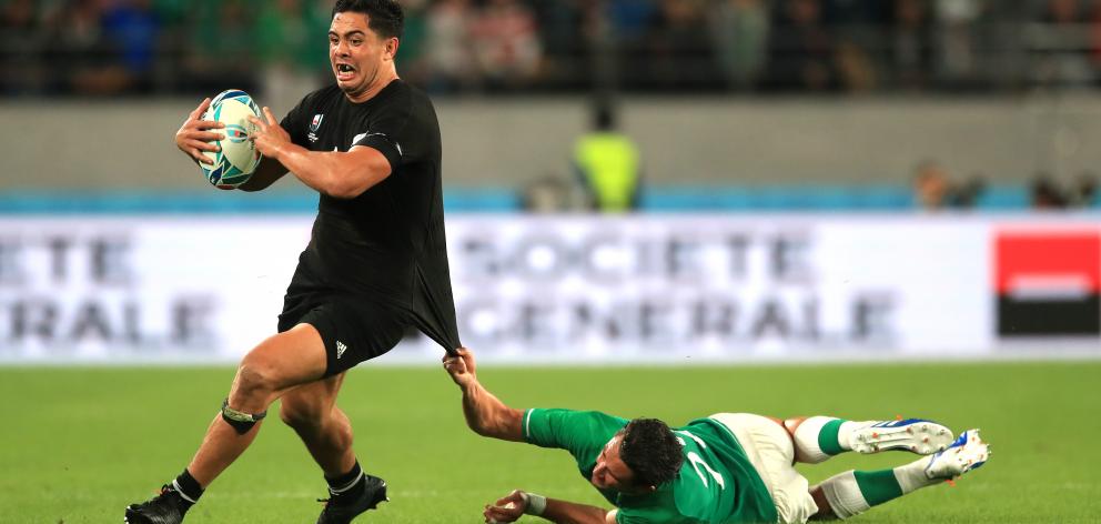 All Black midfield back Anton Lienert-Brown tries to get away from Irish replacement back Joey...