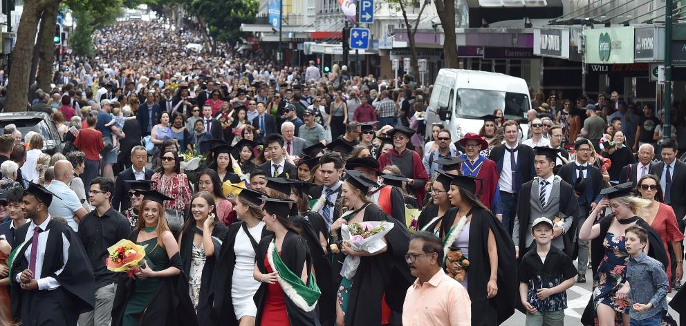 Hundreds of University of Otago graduands move along George St on Saturday before two graduation...