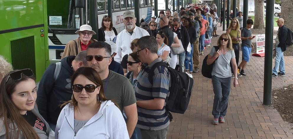 Cruise ship passengers board shuttle buses in the Octagon to get back to their ship. PHOTO:...