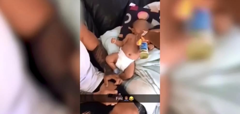 A baby appears to be fed a Long White vodka soda drink.  Photo: Supplied