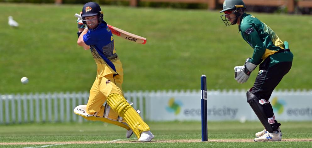Otago batsman Nick Kelly hits the ball through the offside at the University of Otago Oval...