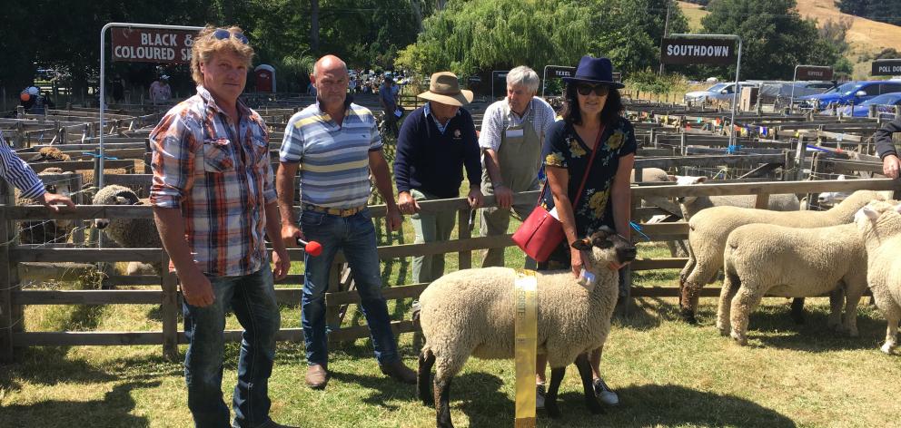 Harry Harrington (left), one of the sponsors, and announcer Dave Butterick congratulate Heather Henderson, of Leeston, on winning the coveted all breeds champion ram lamb prize at Little River on Saturday. Photos: David Hill