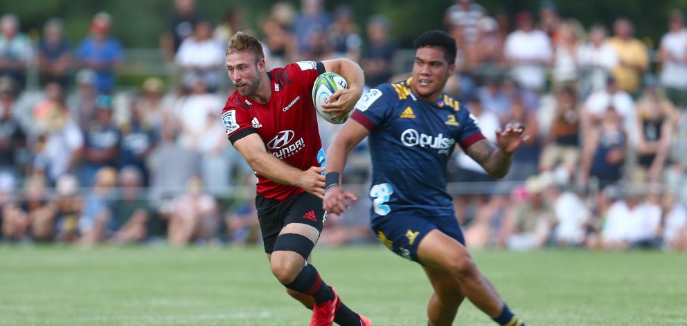 Braydon Ennor, of the Crusaders, wrong-foots Josh Ioane, of the Highlanders, during a Super Rugby...