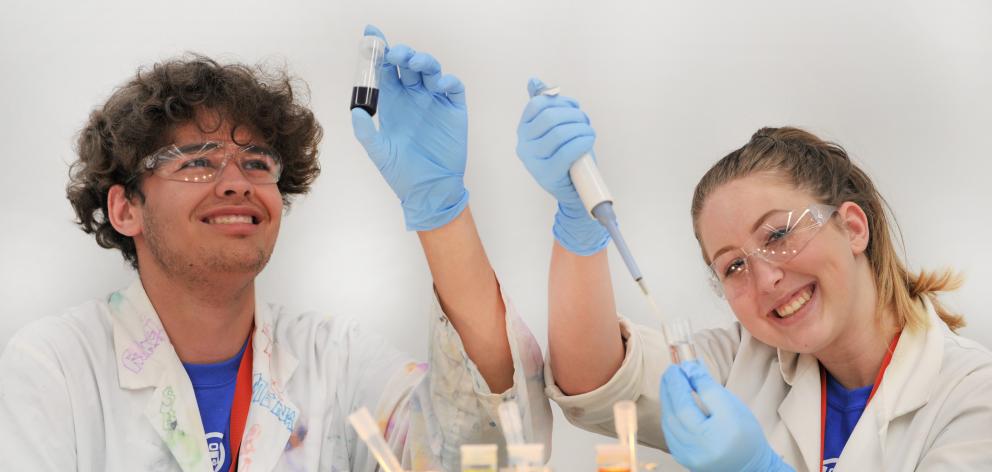 Kahu Hema (17), of Auckland, and Arnia Bradley (16), of Invercargill, help create bright colours at the University of Otago chemistry department yesterday. Photo: Christine O'Connor