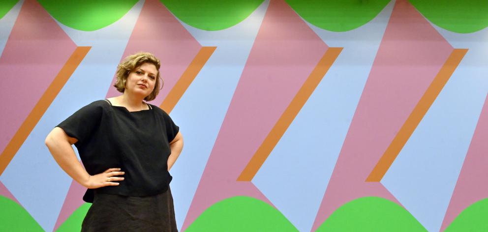 Frances Hodgkins Fellow Imogen Taylor poses in front of Double Portrait: Screw Thread from her ‘‘Sapphic Fragments’’ exhibition at the Hocken Library. Photo: Linda Robertson