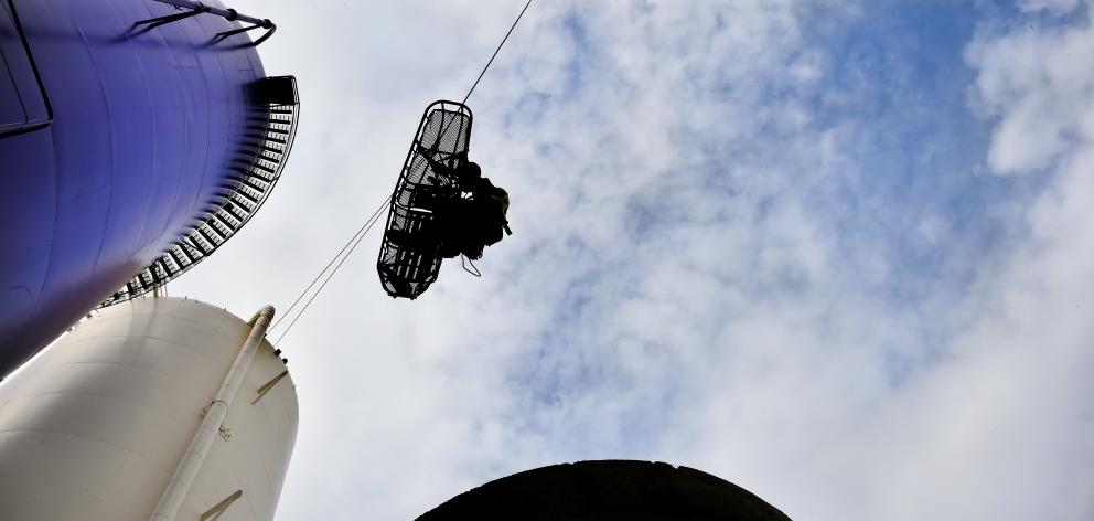 Dunedin senior firefighter Joe Begley is lowered from a silo at the former Cadbury premises...