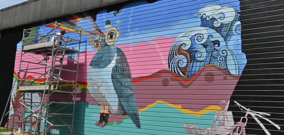 Dunedin artist and relief teacher Guy Howard-Smith is working on a large mural on the side of...