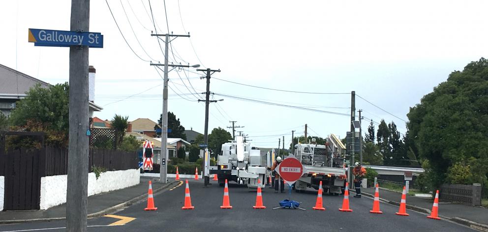 Kenmure Rd was closed while linesmen went to work to fix power lines this evening. Photo:...