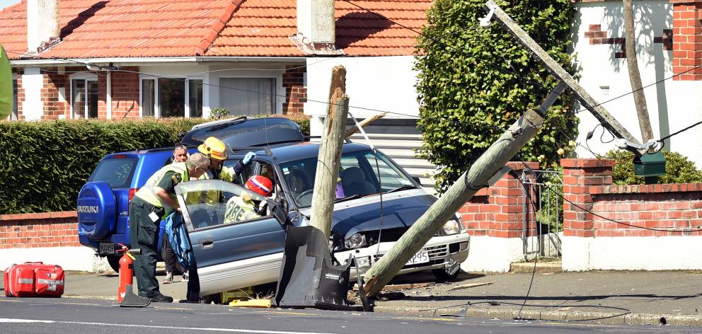 A car hit a power pole on Taieri Rd about midday. Photo: Peter McIntosh