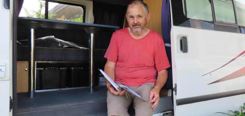 Tony Adams checks through the log book that contains his and Diane’s camper van adventures.