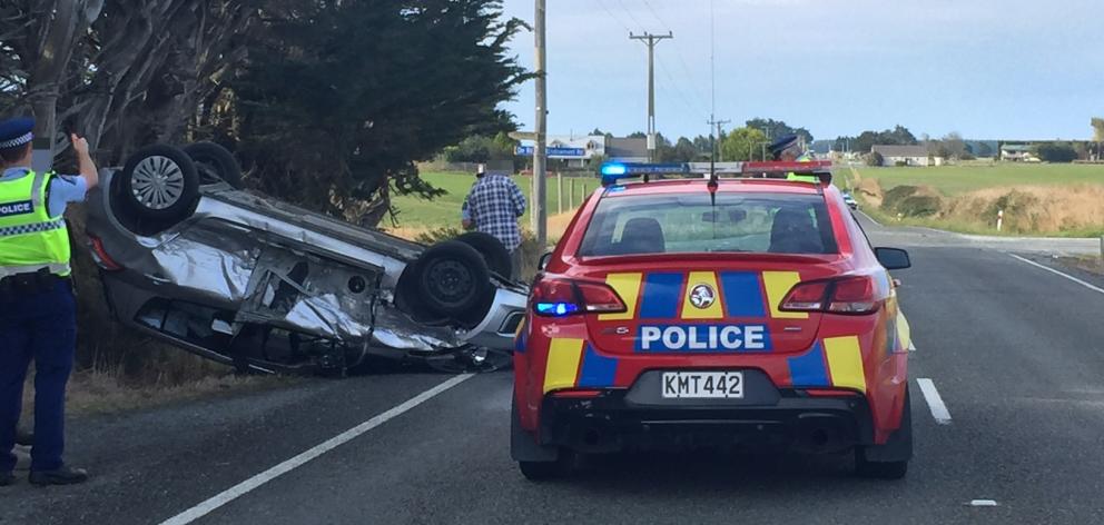 A car rolled after a crash on Kennington-Waimatua Rd today. Photo: Luisa Girao