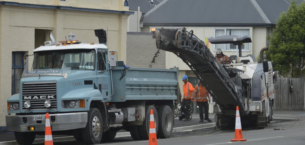 Fulton Hogan contractors use a milling machine to strip old asphalt from the surface of Great...