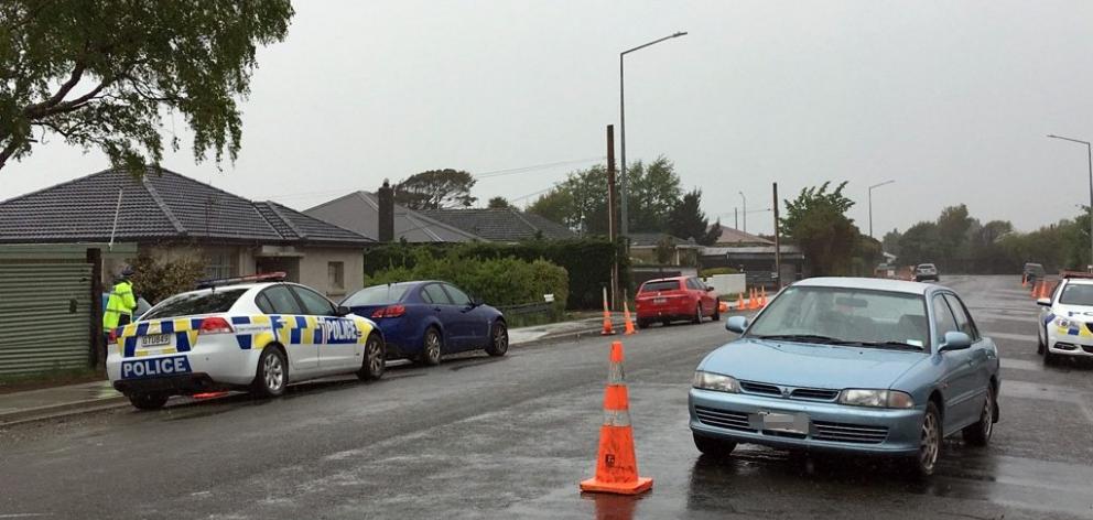Armed police stand outside a South City property in Invercargill yesterday, where a man was found...